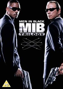 Cover of Men in Black Trilogy DVD set. Will Smith and Tommy Lee Jones hold sci-fi weapons.