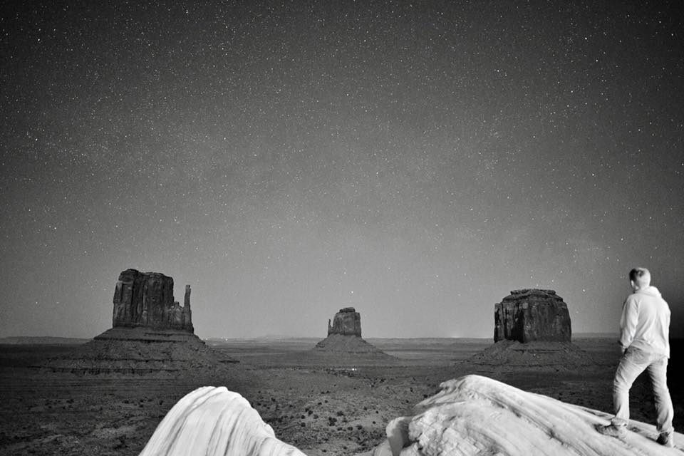 Self-portrait photo of Sean Tomlinson in front of the buttes of Monument Valley.