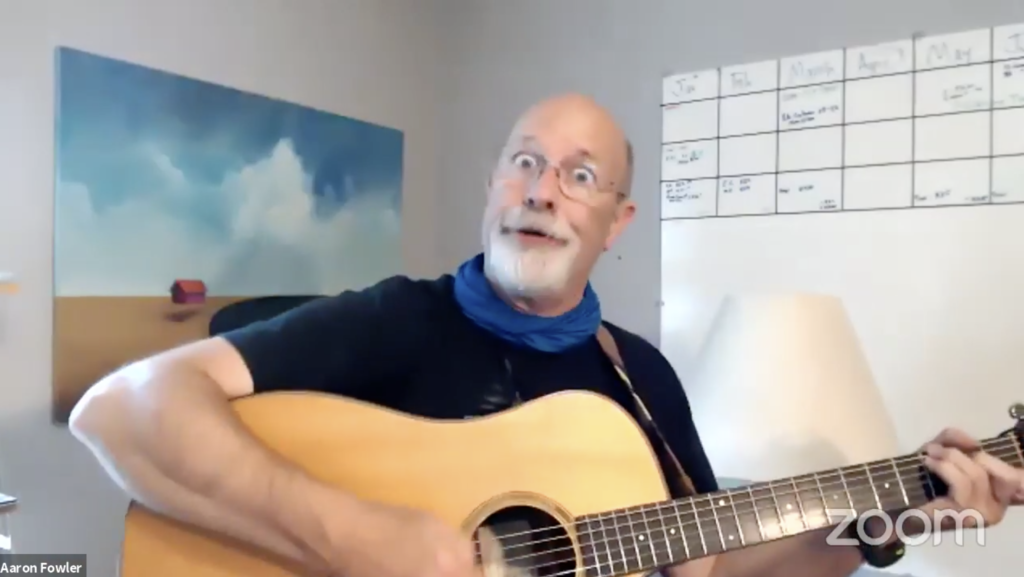 Youth performer Aaron Fowler makes a goofy face while playing the guitar.