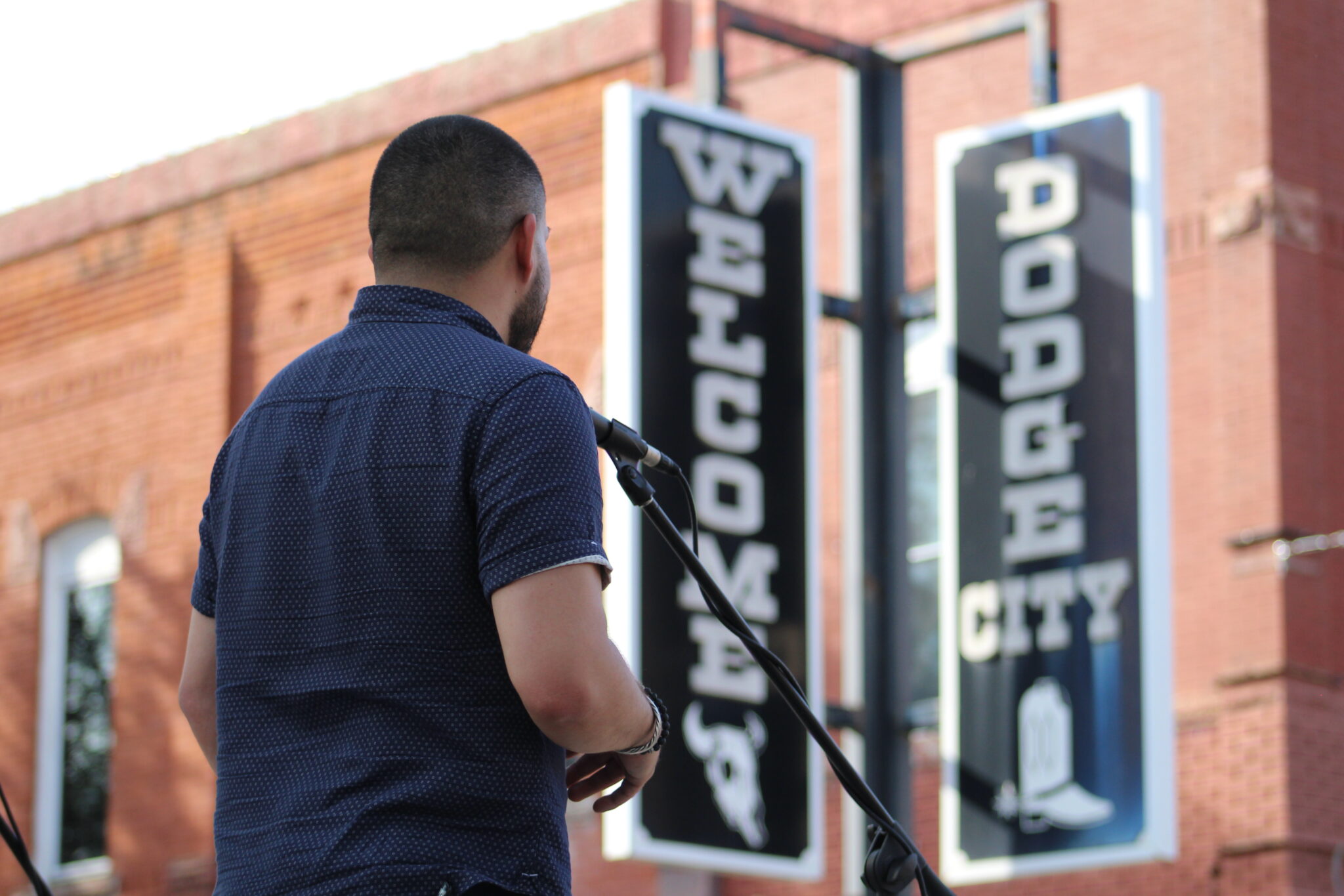 Kansas Poet Laureate Huascar Medina reads outside the Carnegie Center for the Arts in Dodge City International Festival in September 2019