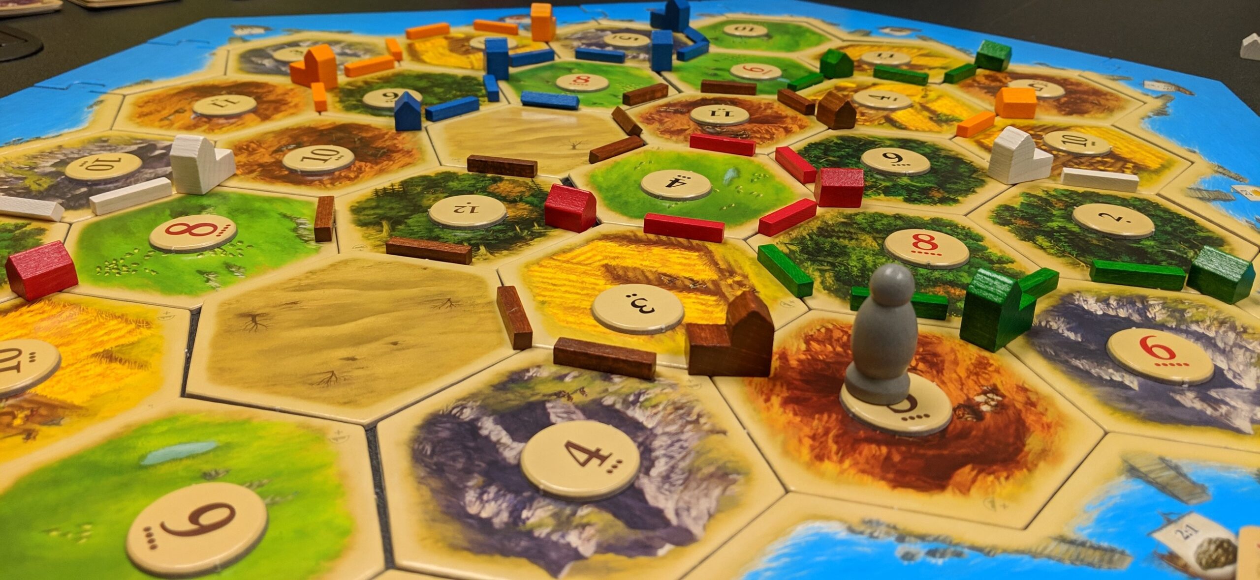 A game board with a game of Settlers of Catan in progress.